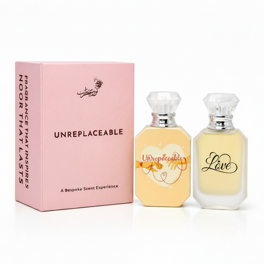 Two perfume bottles with 'Love' text and a pink box on a white background